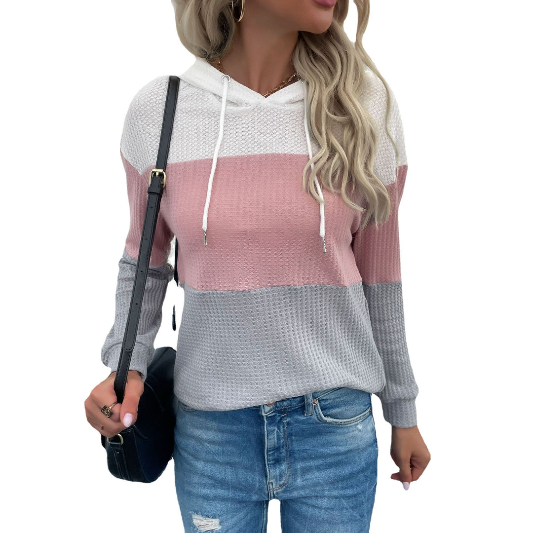 Sienna color block hoodie, full front view against textured wall