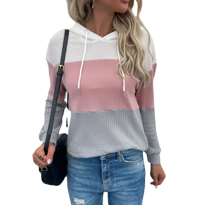 Sienna color block hoodie, full front view against textured wall
