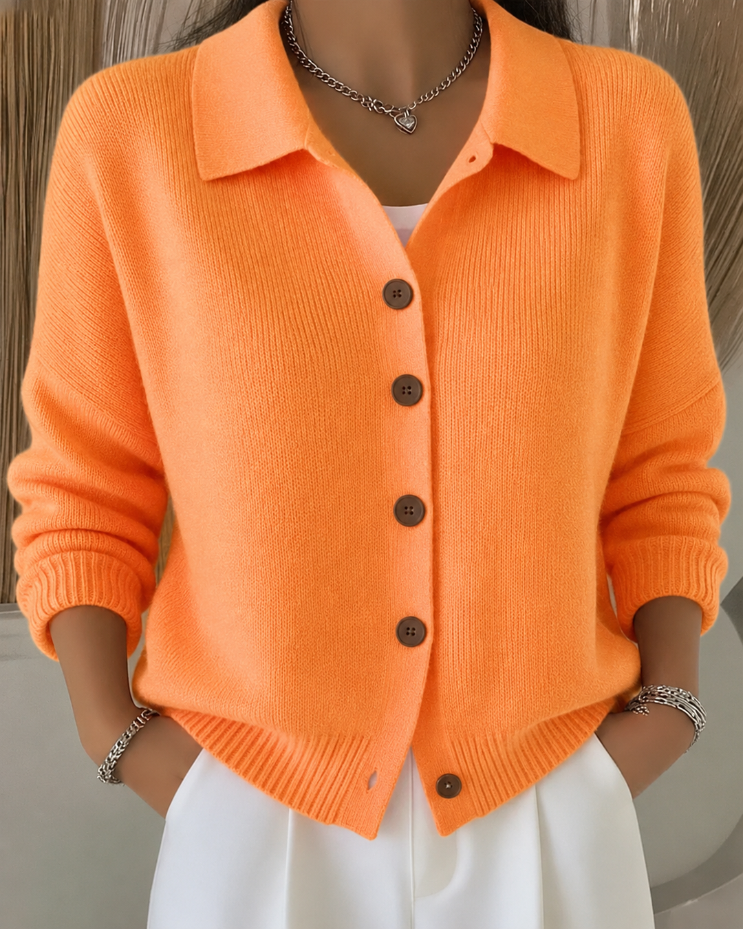 Sienna orange button collar cardigan, front view styled with white skirt