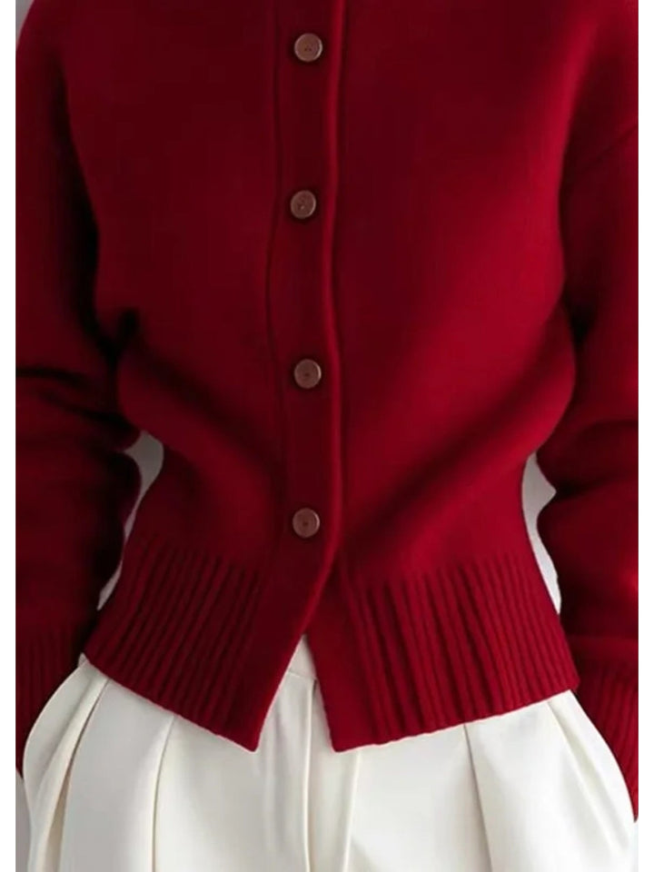 Simone high-neck button cardigan in red, close-up button and hem detail