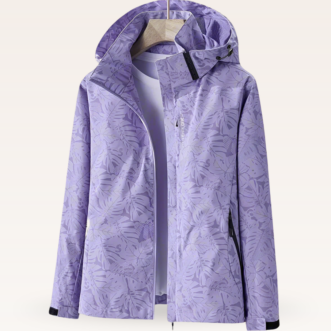 Thea hooded rain jacket in pink leaf print, front view on hanger