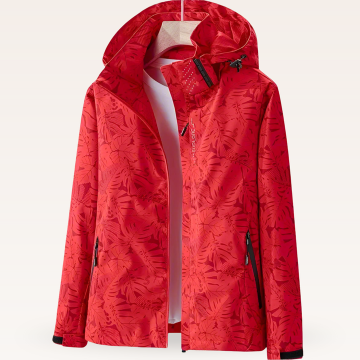 Thea hooded rain jacket in pink leaf print, front view on hanger