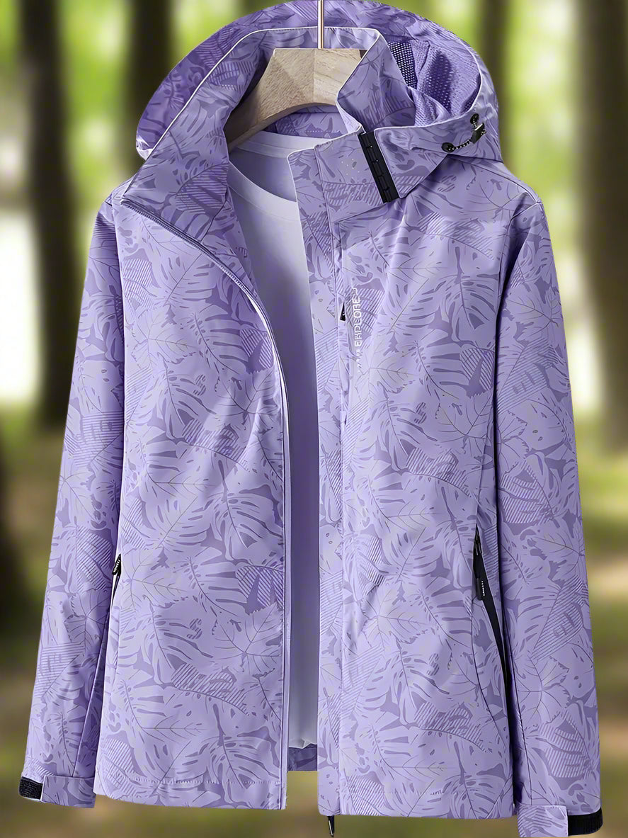 Thea hooded rain jacket in purple leaf print, front view on hanger