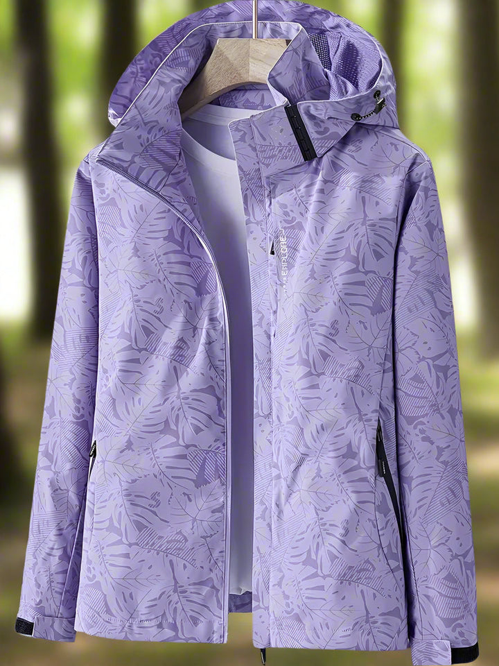 Thea hooded rain jacket in purple leaf print, front view on hanger