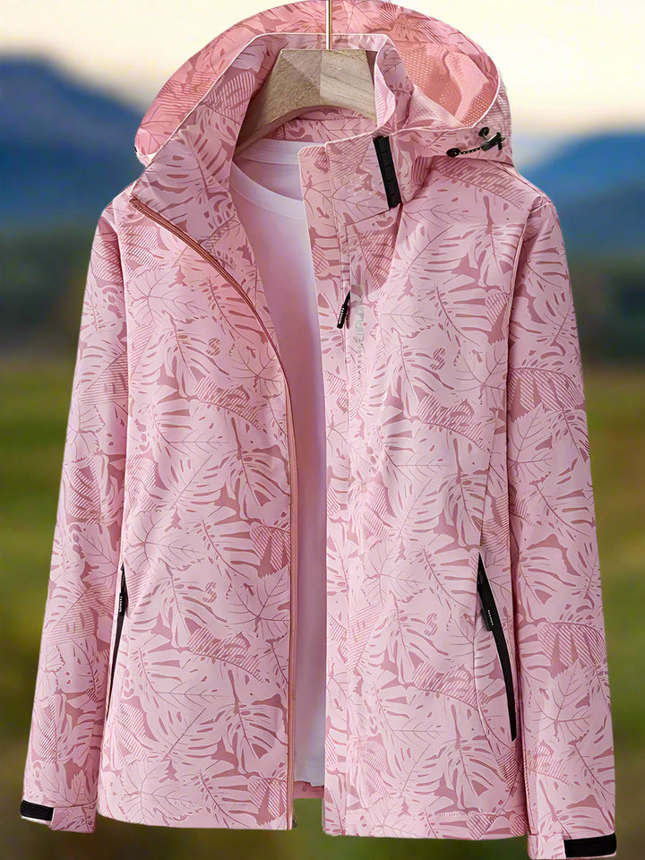 Thea hooded rain jacket in pink leaf print, front view on hanger