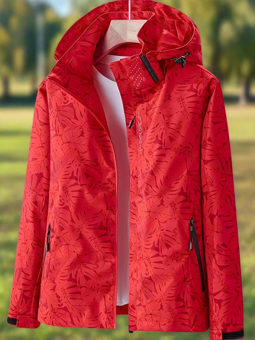 Thea hooded rain jacket in pink leaf print, front view on hanger