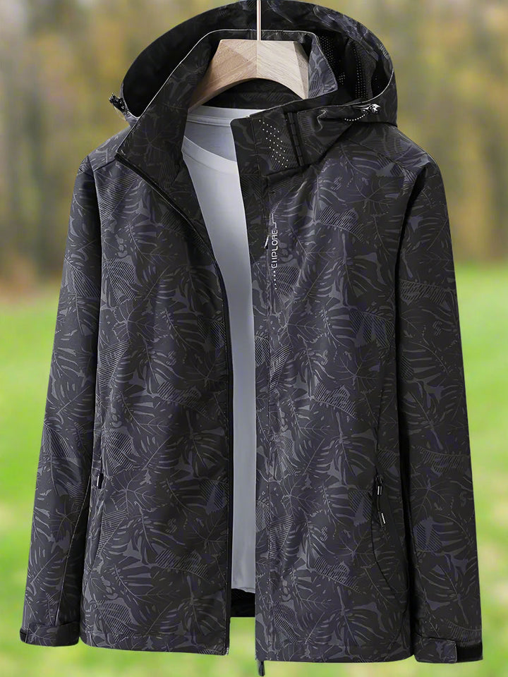 Thea hooded rain jacket in pink leaf print, front view on hanger