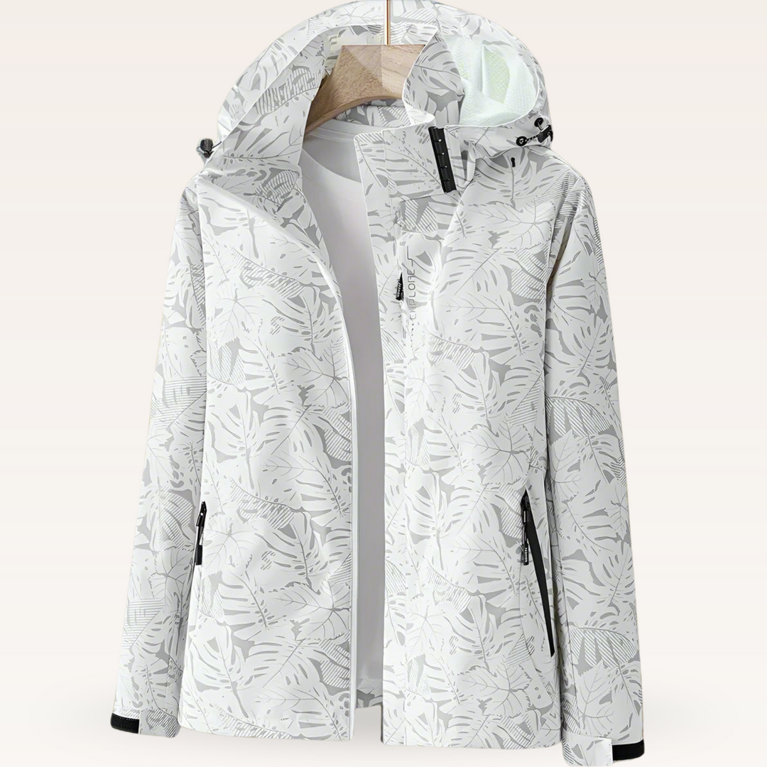 Thea hooded rain jacket in pink leaf print, front view on hanger