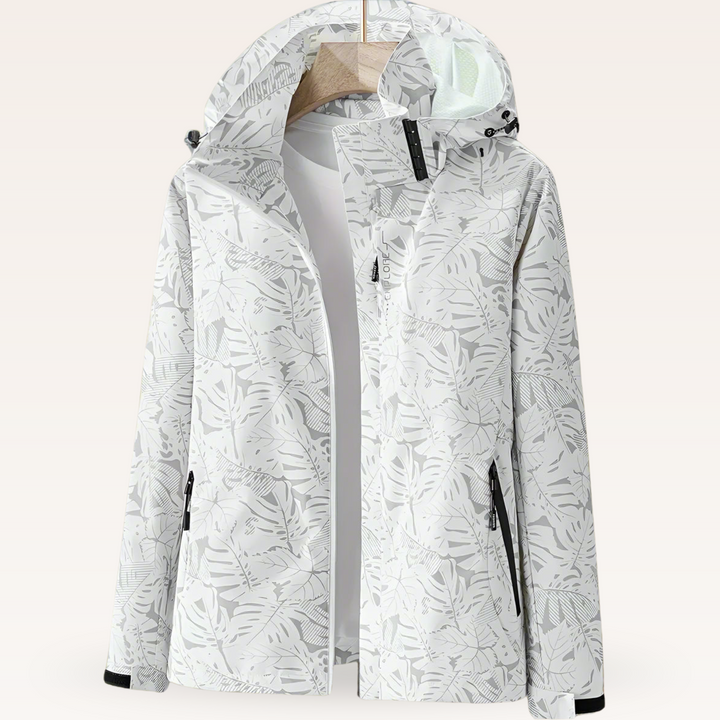 Thea hooded rain jacket in pink leaf print, front view on hanger
