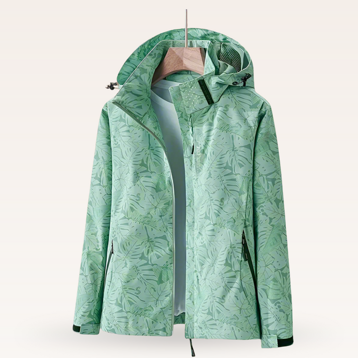 Thea hooded rain jacket in pink leaf print, front view on hanger