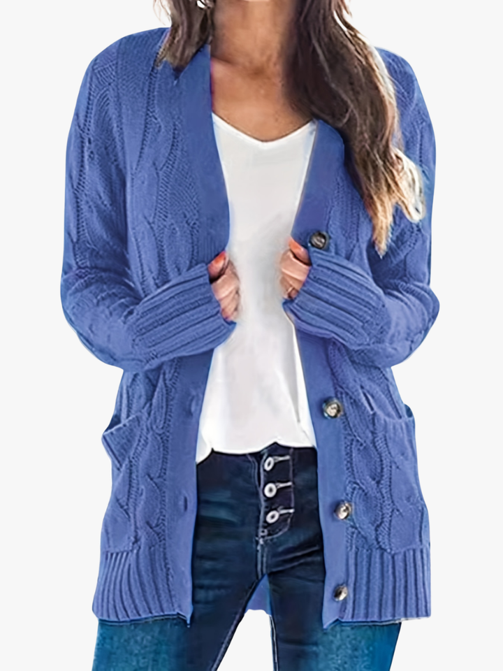 Vivienne cable knit button cardigan in blue, front view with hands in pockets