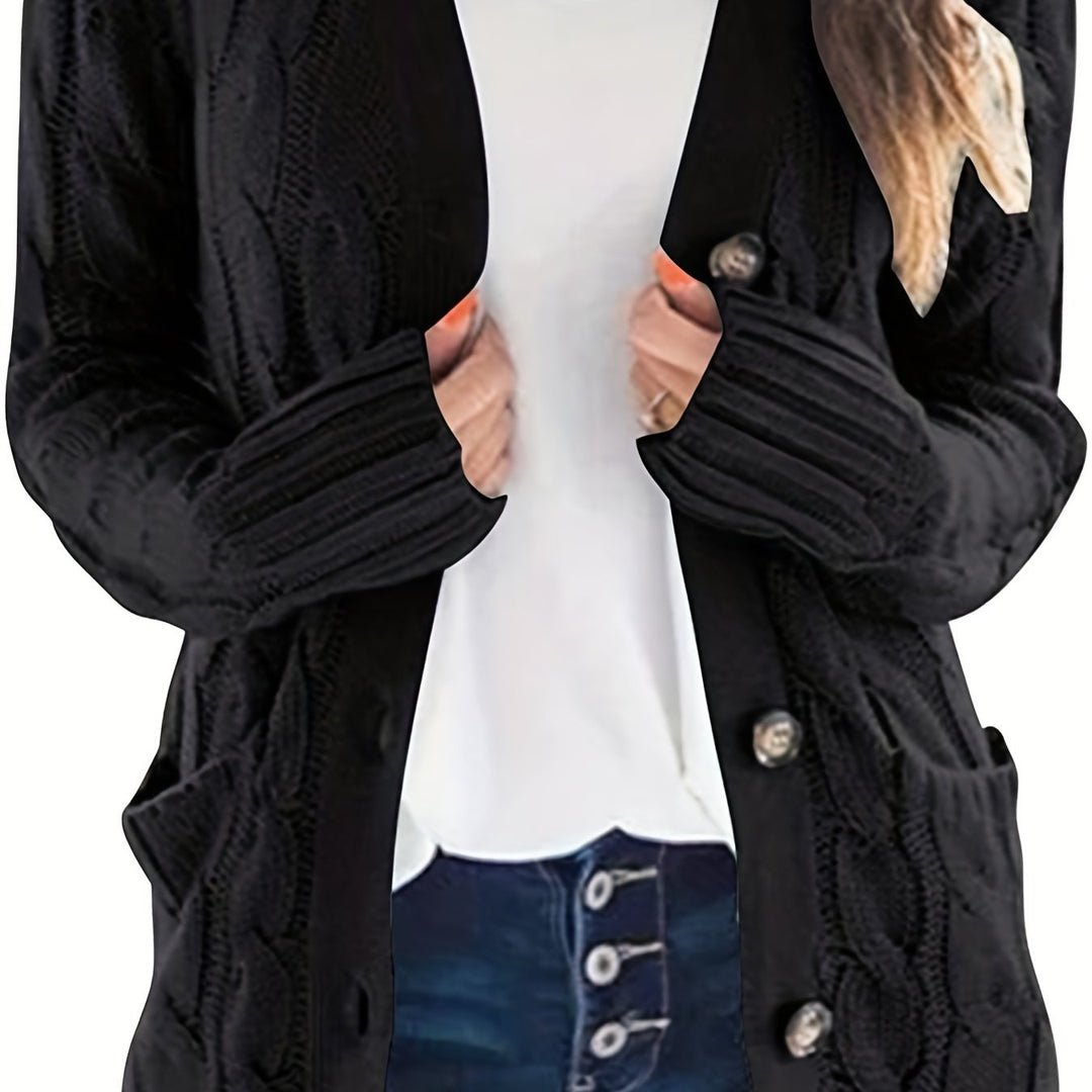 Vivienne cable knit button cardigan in black, front view with hands in pockets