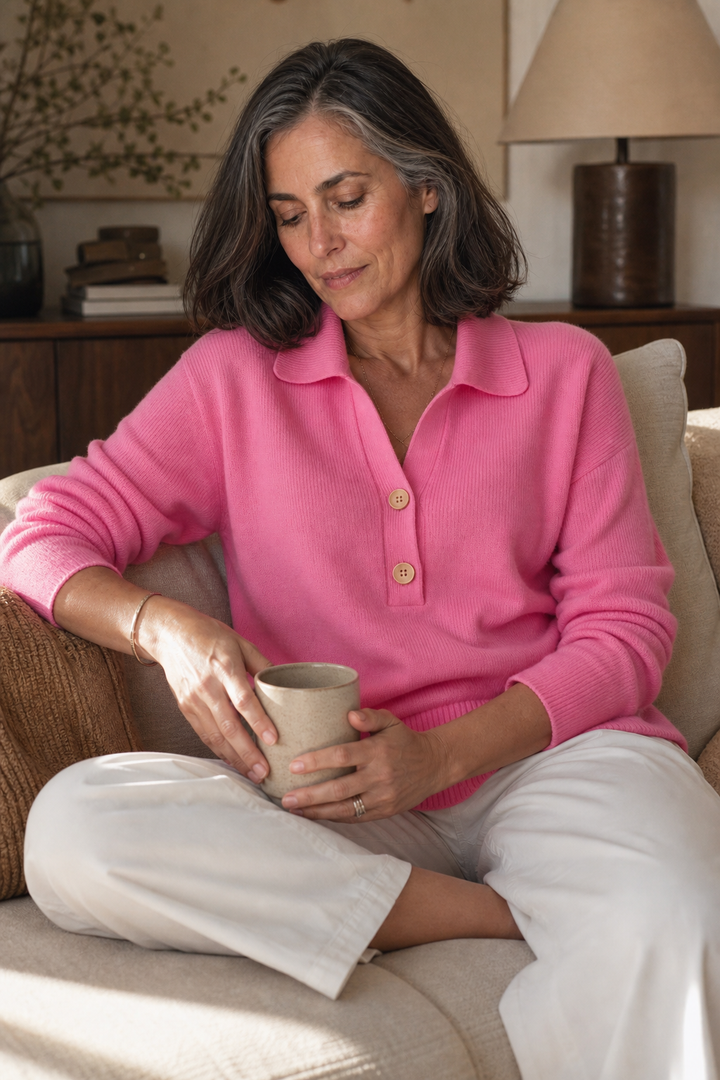 Wilhelmina pink collared pullover sweater styled with a trench coat and white pants