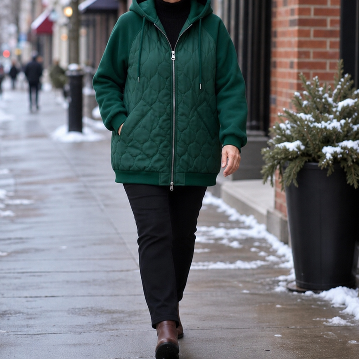 Winter dark green quilted hooded puffer jacket, full-length walking view