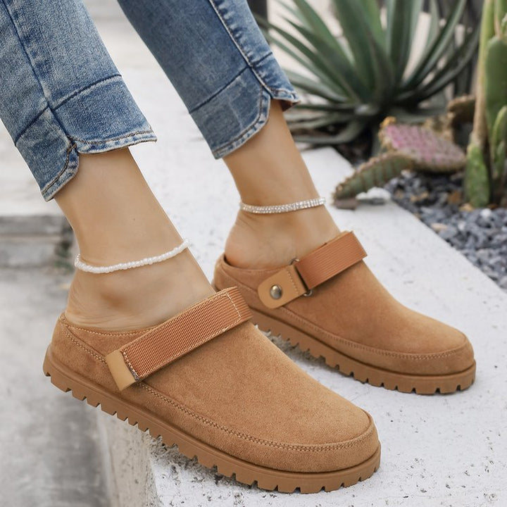 Thalia tan adjustable strap platform clogs worn outdoors, side view