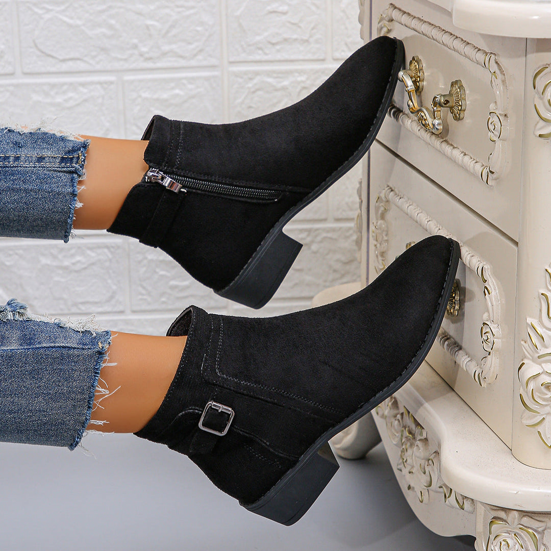 Harlow black ankle boots with buckle strap, close-up on model