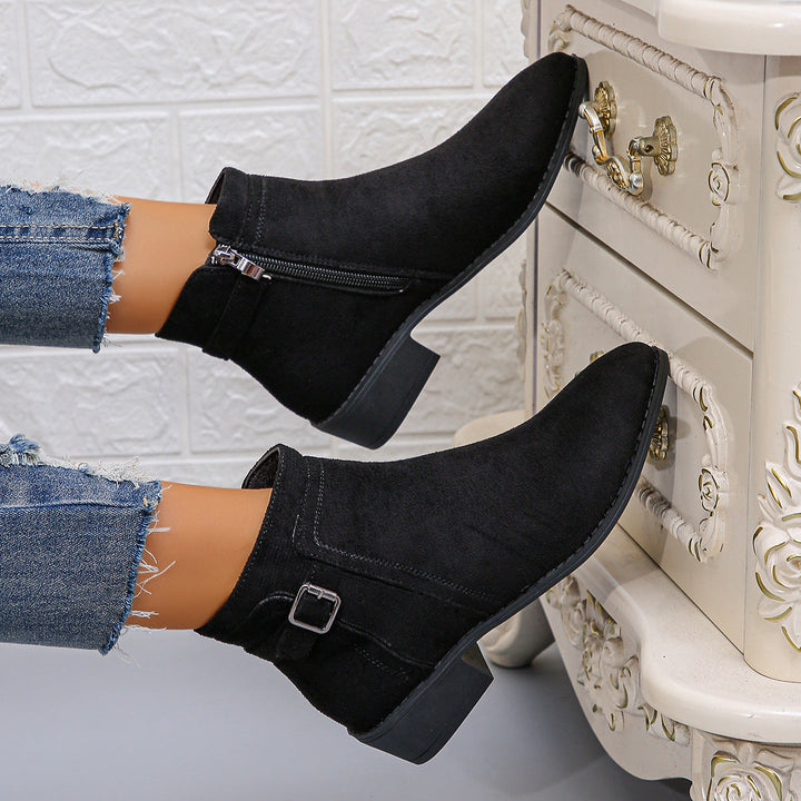 Harlow black ankle boots with buckle strap, close-up on model