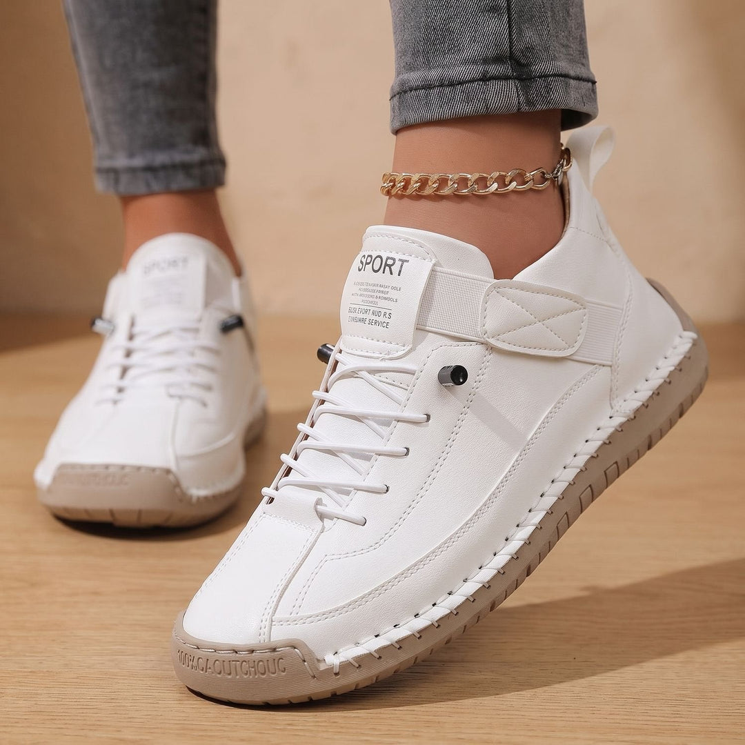 Faye white low-top sneakers worn on feet, front angle showing contrast stitching