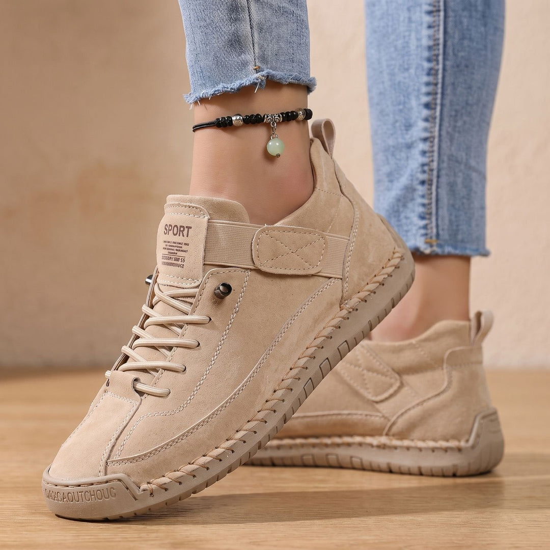 Faye beige low-top sneakers worn on feet, side view with ankle strap detail