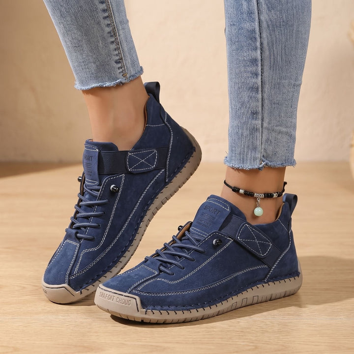 Faye black low-top sneakers worn on feet, side profile walking shot