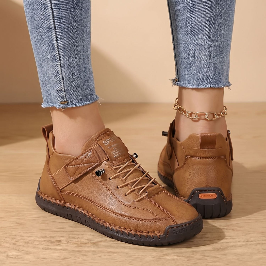 Faye black low-top sneakers worn on feet, side profile walking shot