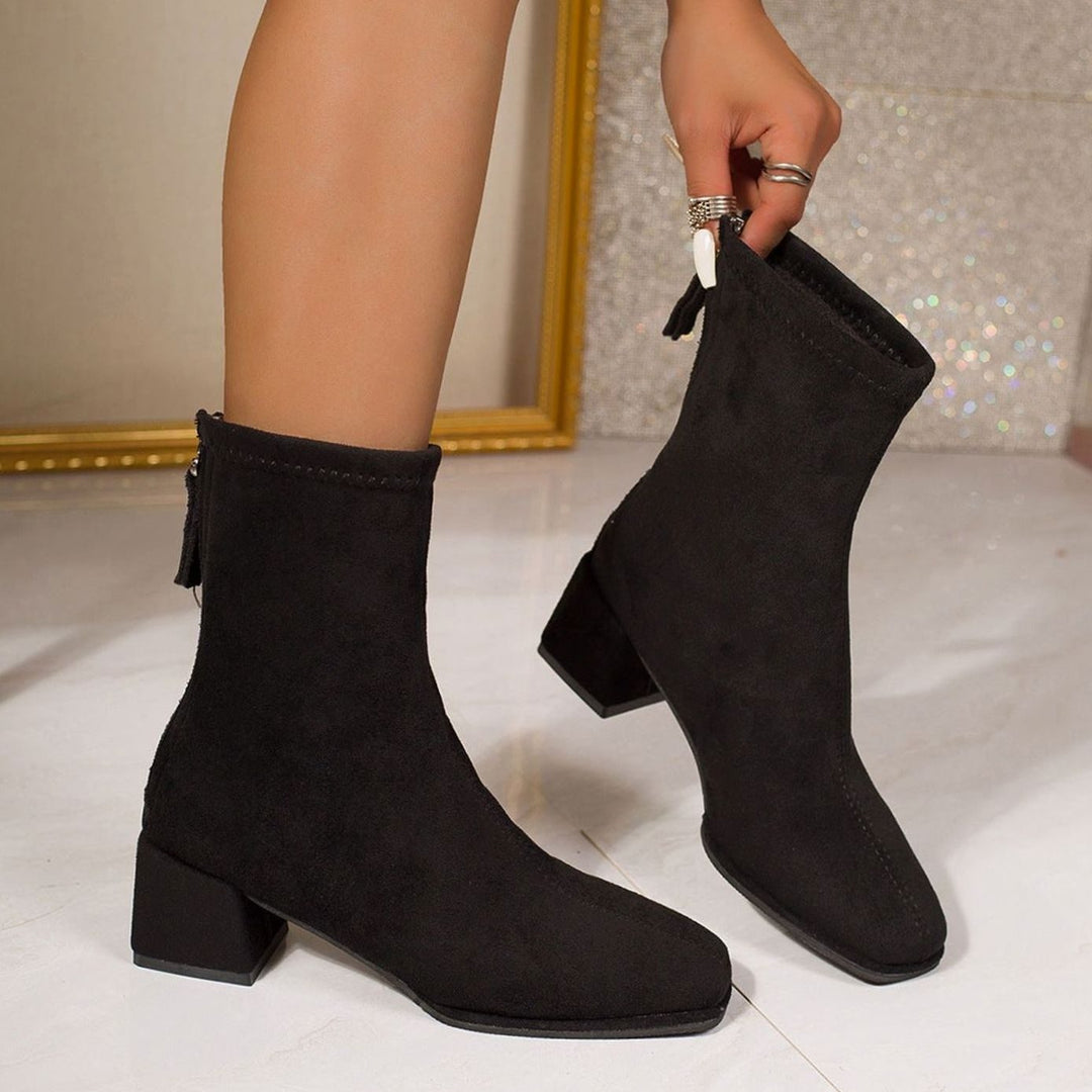 Marigold block heel ankle boots with square toe, side view being put on