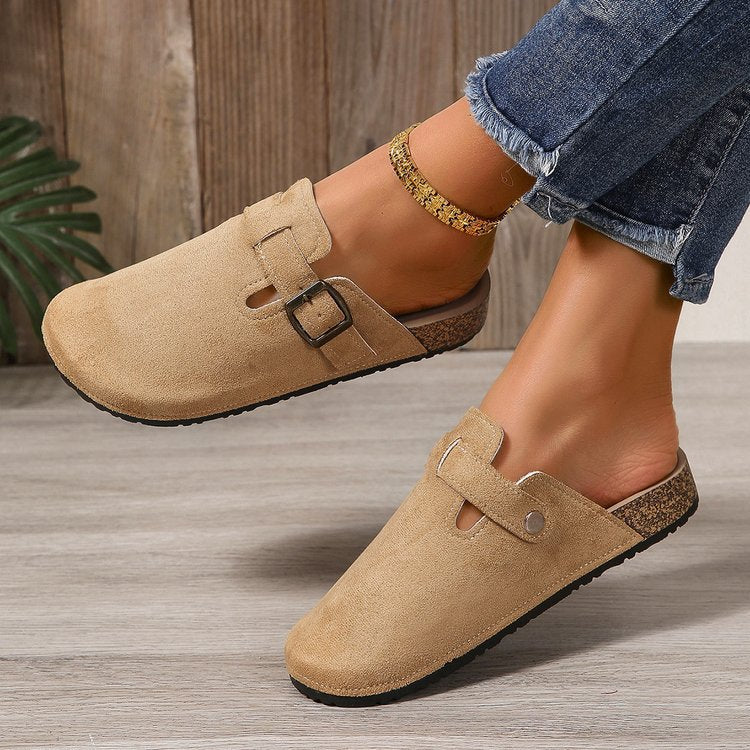 Delphine buckle clogs worn on model, side profile