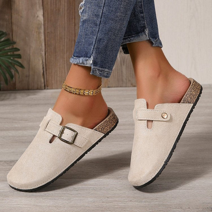 Delphine buckle clogs worn on model, front angle view
