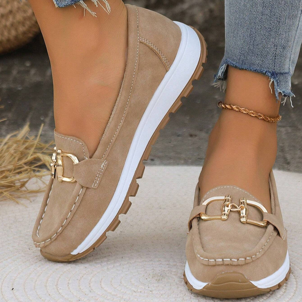 Odette slip-on loafers with gold buckle detail, outdoor setting