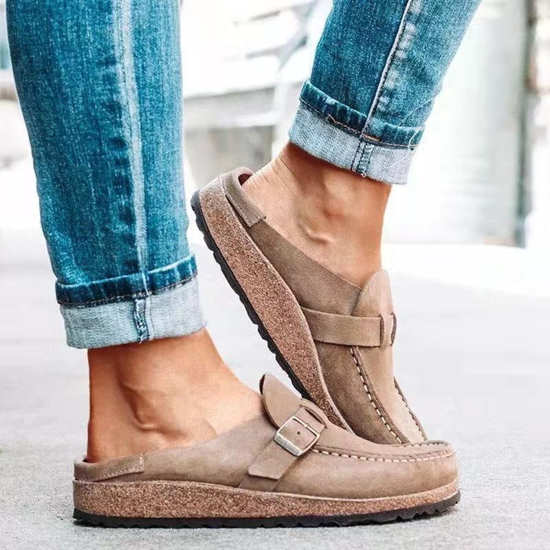 Felicity buckle strap backless clogs in taupe, side view on model