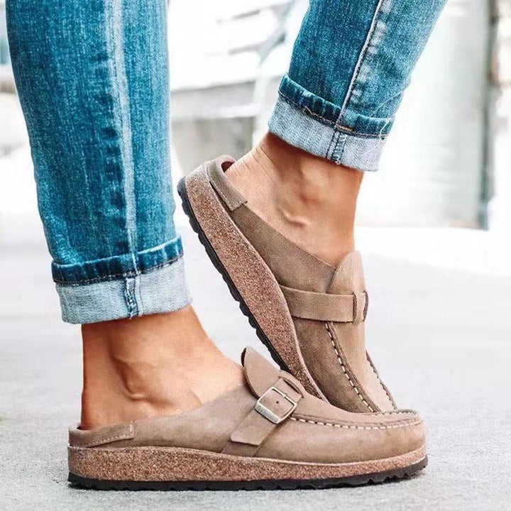 Felicity buckle strap backless clogs in taupe, side view on model