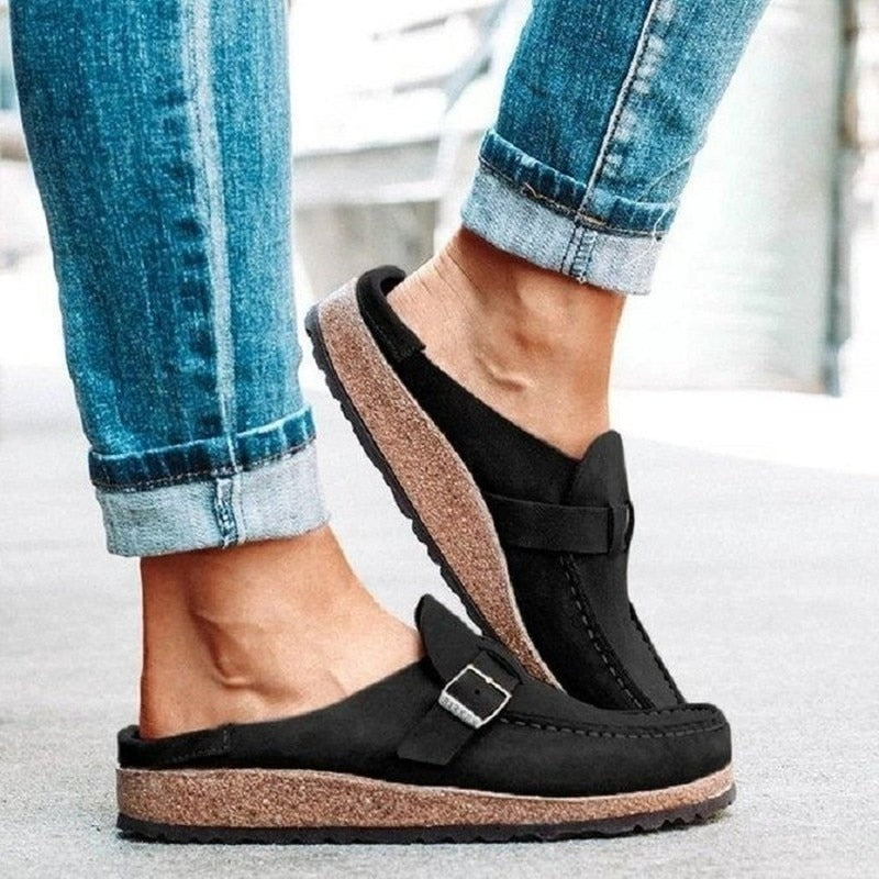 Felicity buckle strap backless clogs in black, side view on model