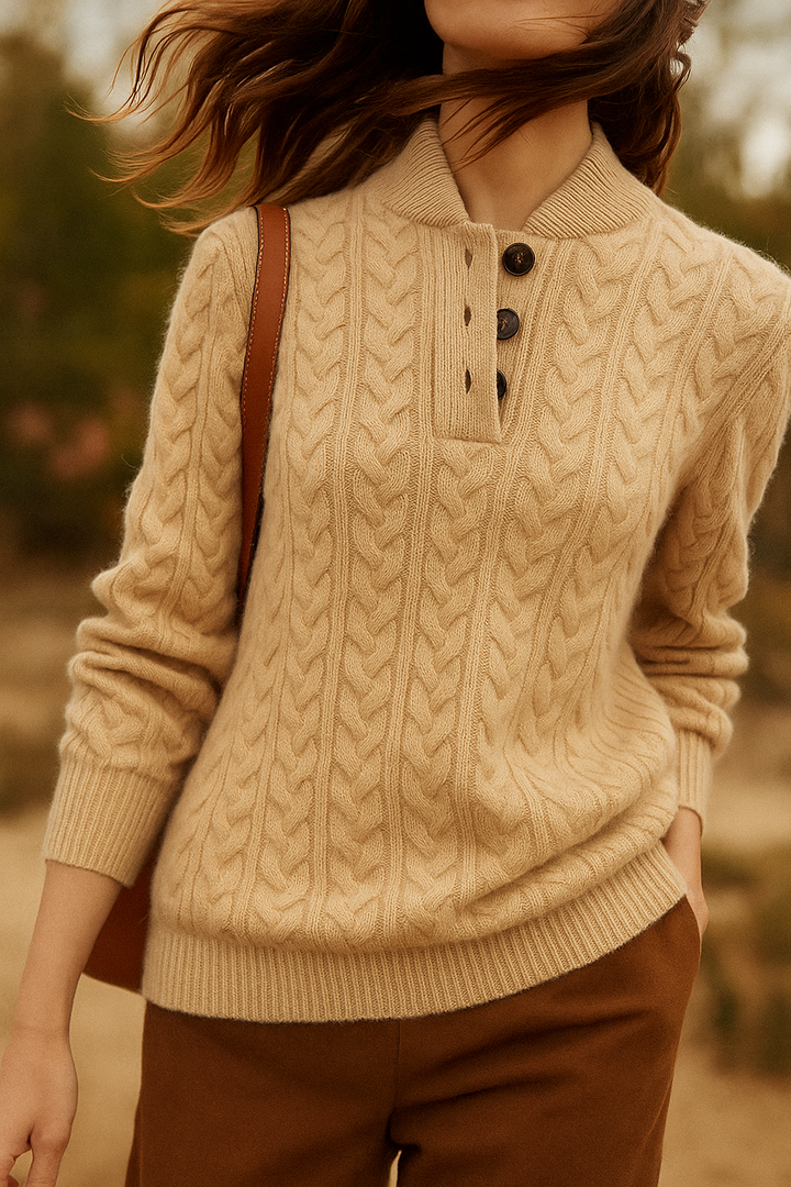Marigold cable-knit button-up sweater styled with earrings, close-up