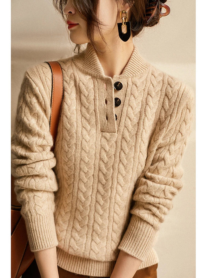 Marigold cable-knit button-up sweater styled with earrings, close-up