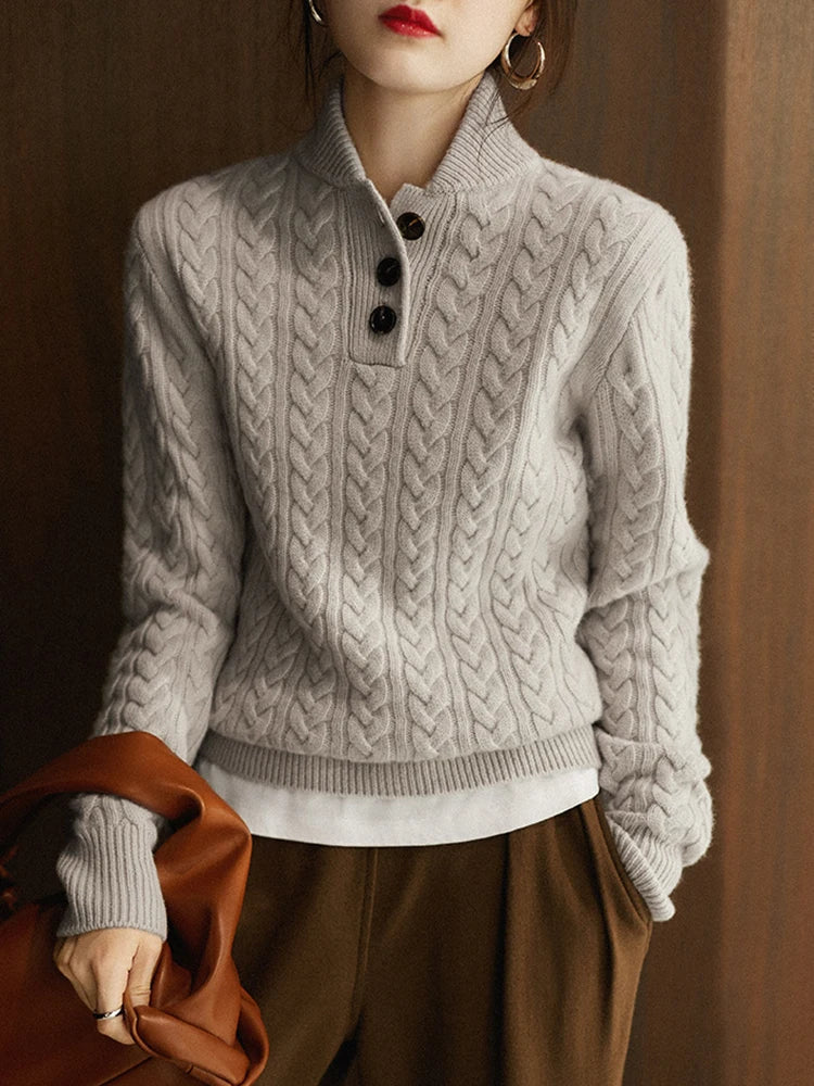 Marigold cable-knit button-up sweater styled with earrings, close-up