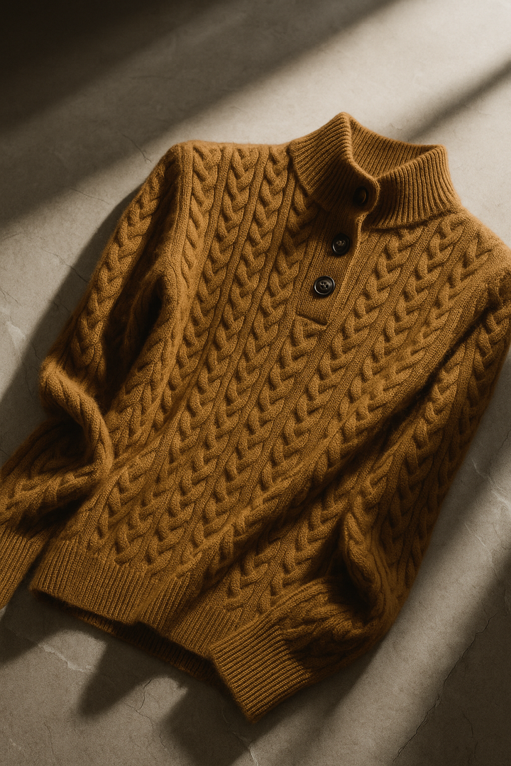 Marigold cable-knit button-up sweater styled with earrings, close-up
