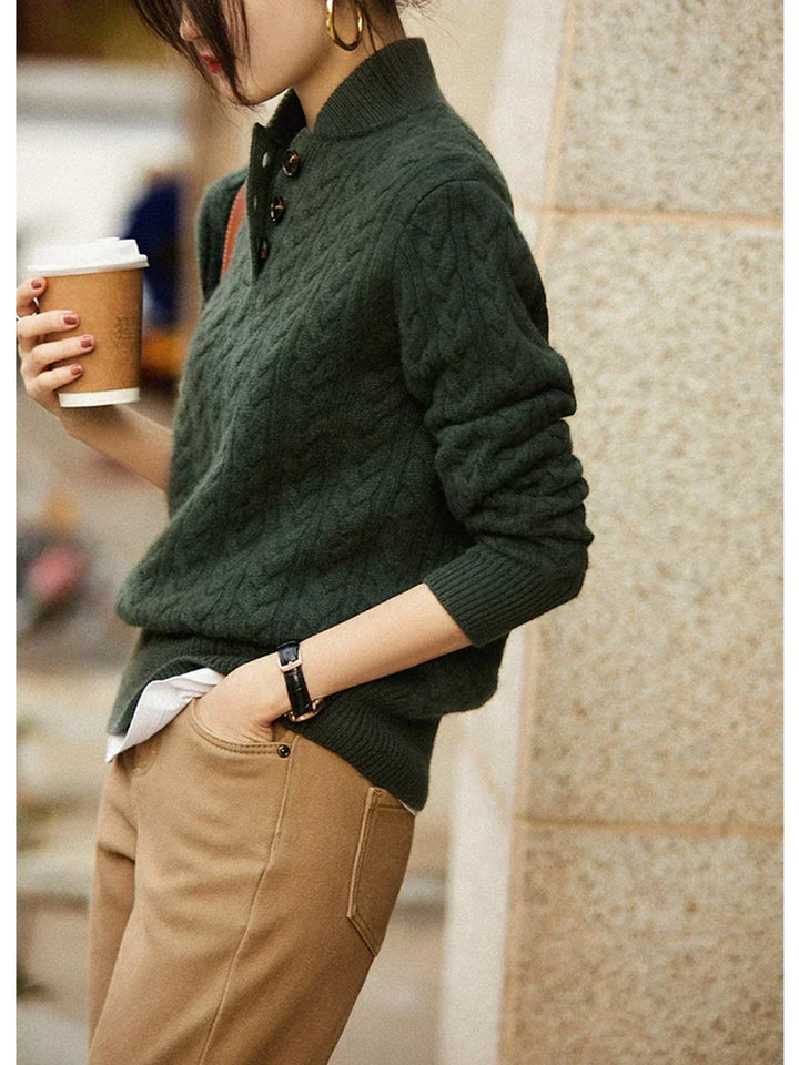 Marigold cable-knit button-up sweater styled with earrings, close-up