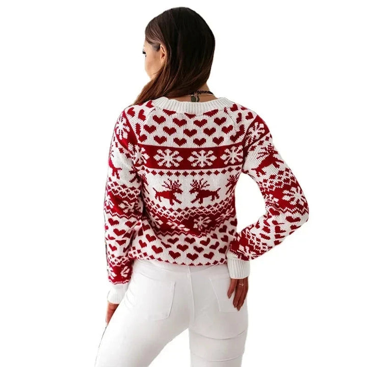 Marigold Christmas sweater worn seated near holiday decor, front view