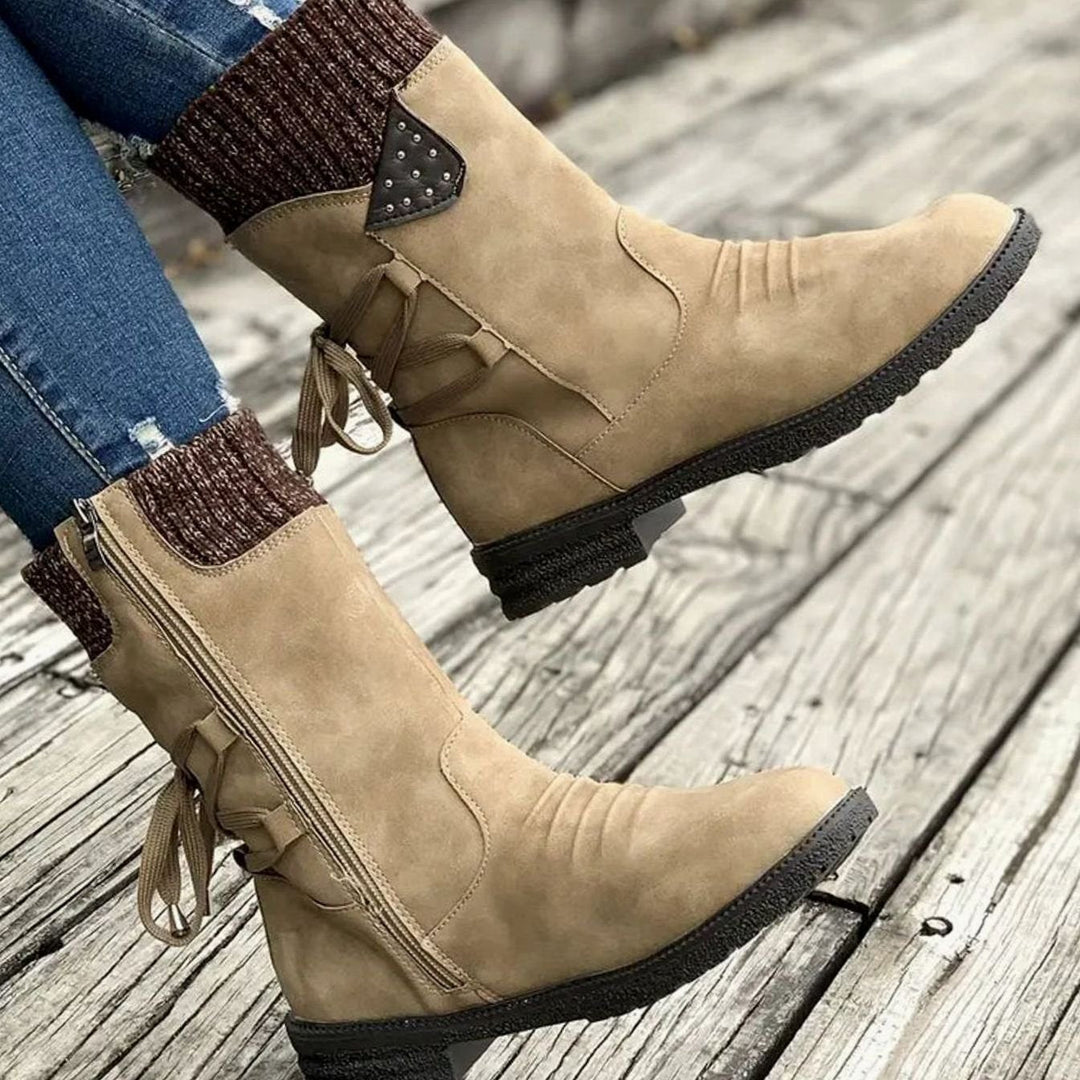 Ophelia tan Chelsea boots with chunky heel and knit cuff, side view on model