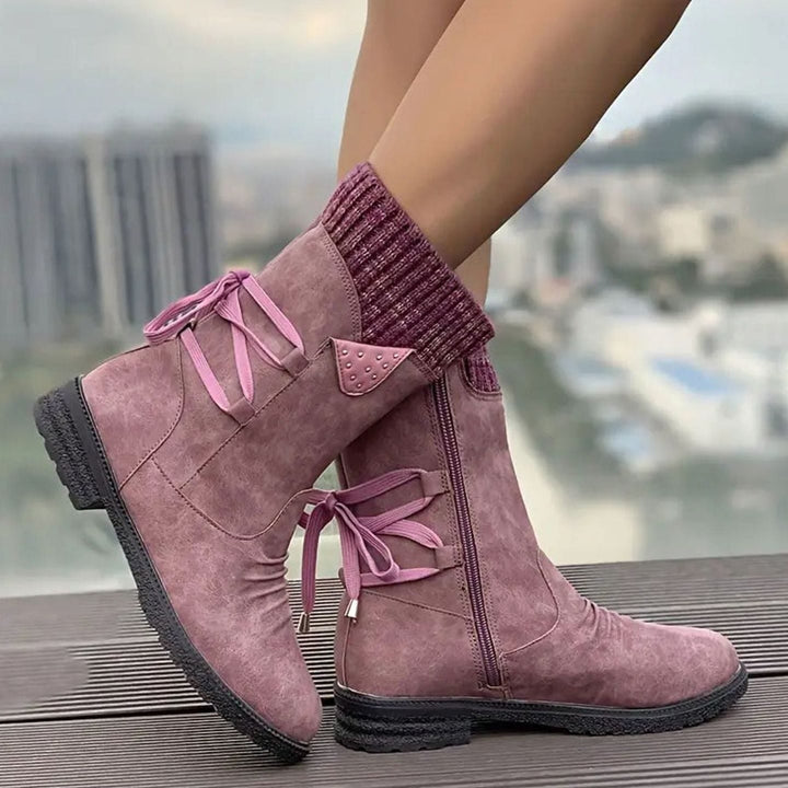 Ophelia pink lace-up ankle boots with studded knit cuff detail, side view on model