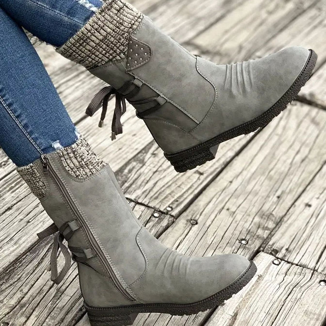 Ophelia pink lace-up ankle boots with studded knit cuff detail, side view on model
