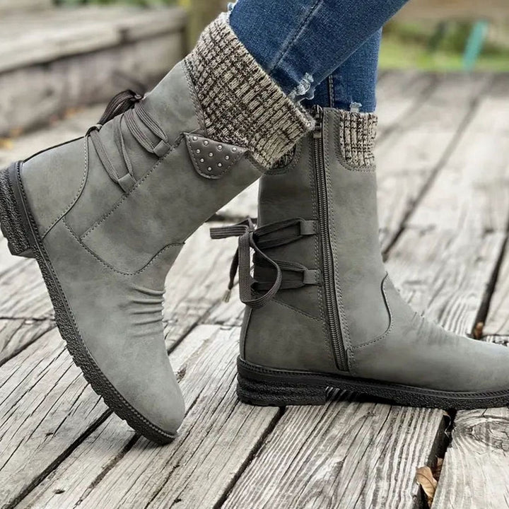 Ophelia pink lace-up ankle boots with studded knit cuff detail, side view on model