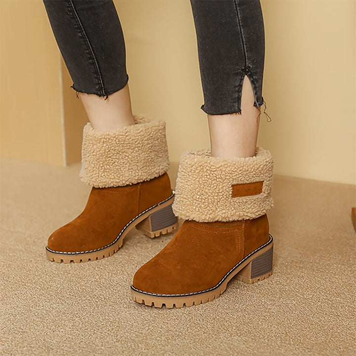 Rosalyn cuffed winter boots held in hand, close-up detail