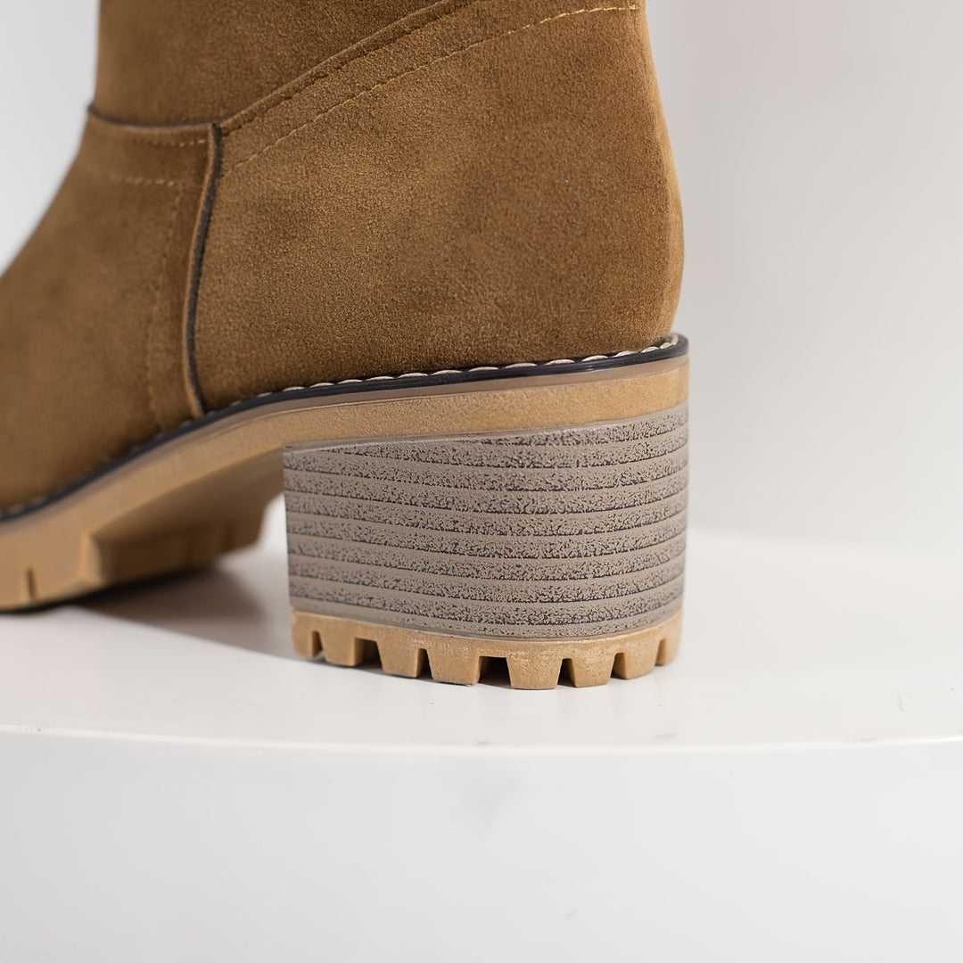 Rosalyn cuffed winter boots held in hand, close-up detail