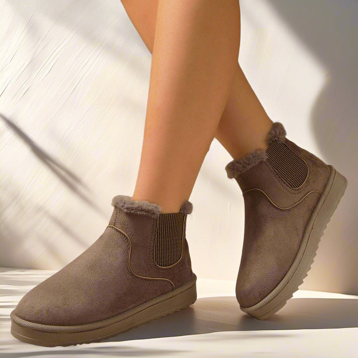 Marlowe faux fur lined Chelsea ankle boots in taupe, side view on model