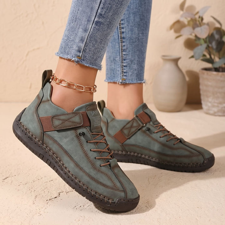Rosalind high-top lace-up sneakers in green, side view on model