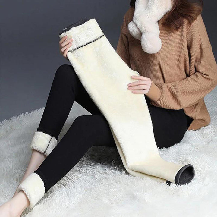 Woman holding up fleece lined legging showing soft brushed interior