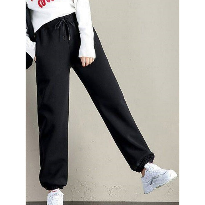 Marisol fleece lined sweatpants in black, side view with sneakers
