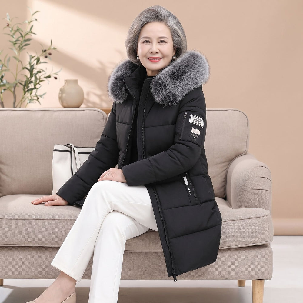 Thessaline hooded puffer jacket with grey faux fur collar in black, seated side view