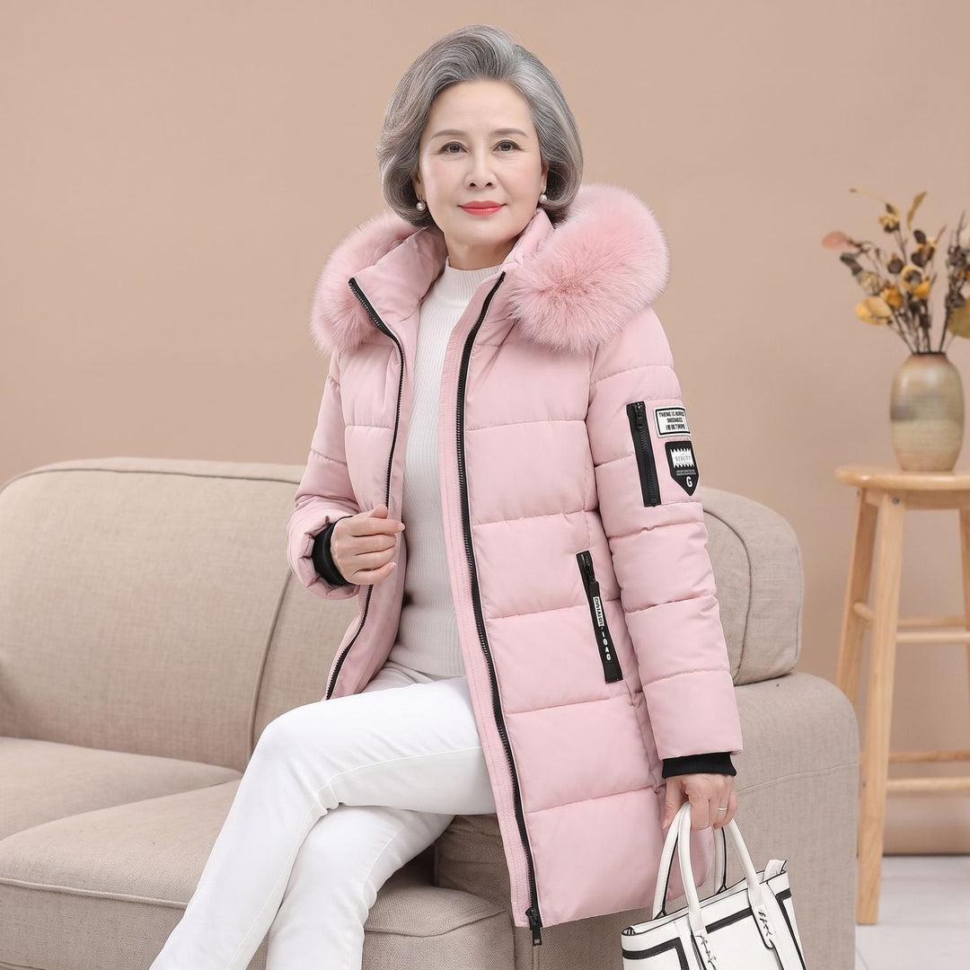 Thessaline hooded puffer jacket with pink faux fur collar, seated front view